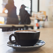 Closeup of a cup of espresso coffee in a cafe setting.