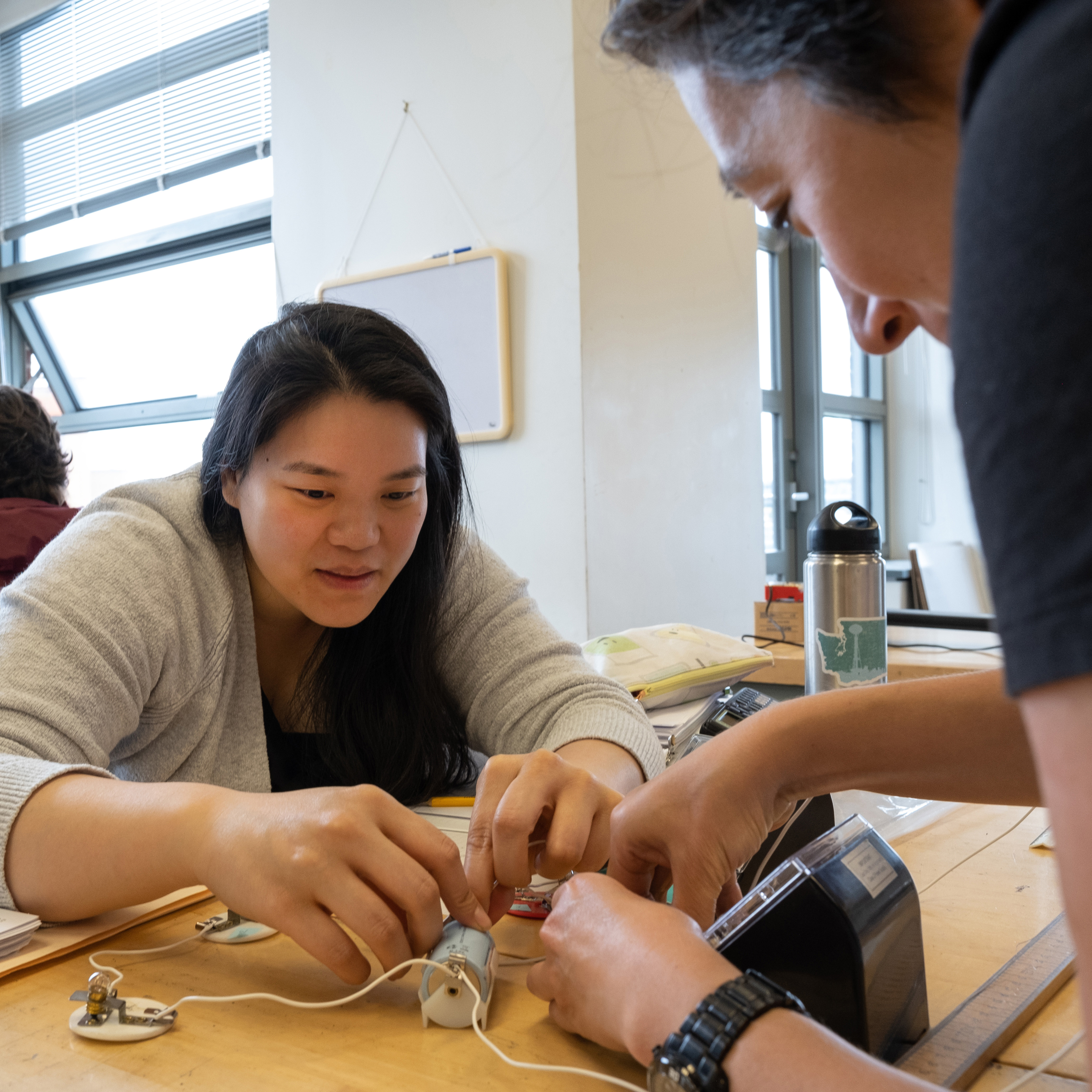 High school teachers conducting a physics experiment at the UW. 